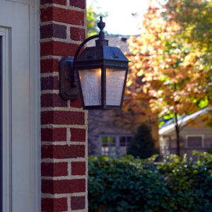 Georgian Lantern EX-5406-A12 brass exterior wall light illuminated beside a brick home entry