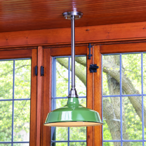 Bistro VA4C0001 vintage pendant light with a green enamel shade installed above wood framed windows