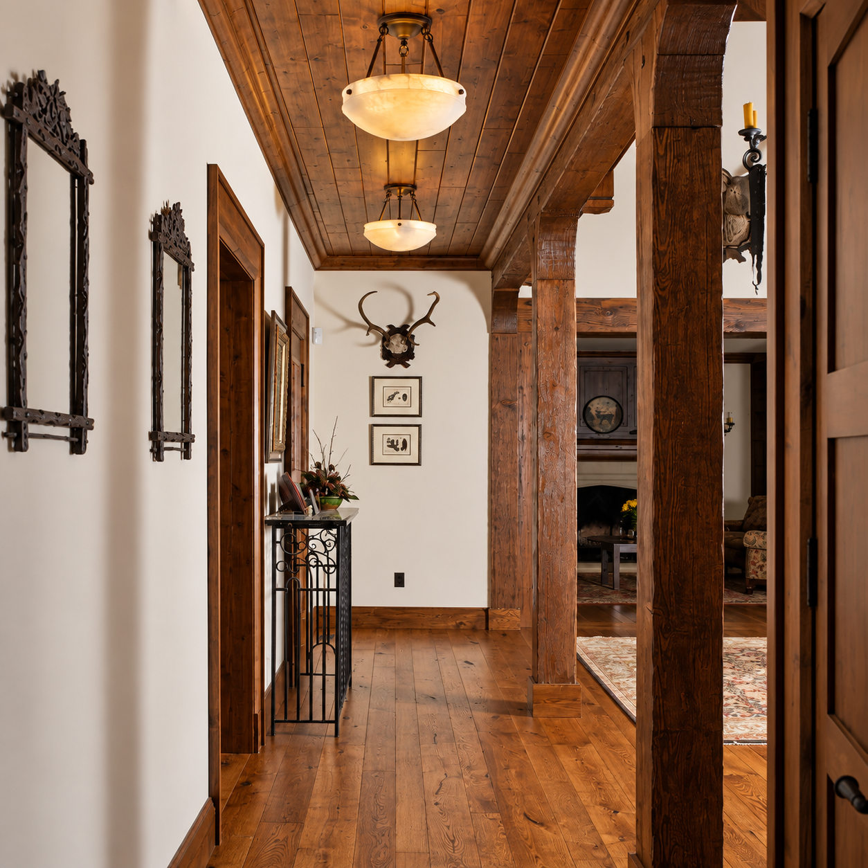Two Tuscany AL-2019-AA-N alabaster ceiling lights illuminating a rustic hallway with wood ceilings and floors